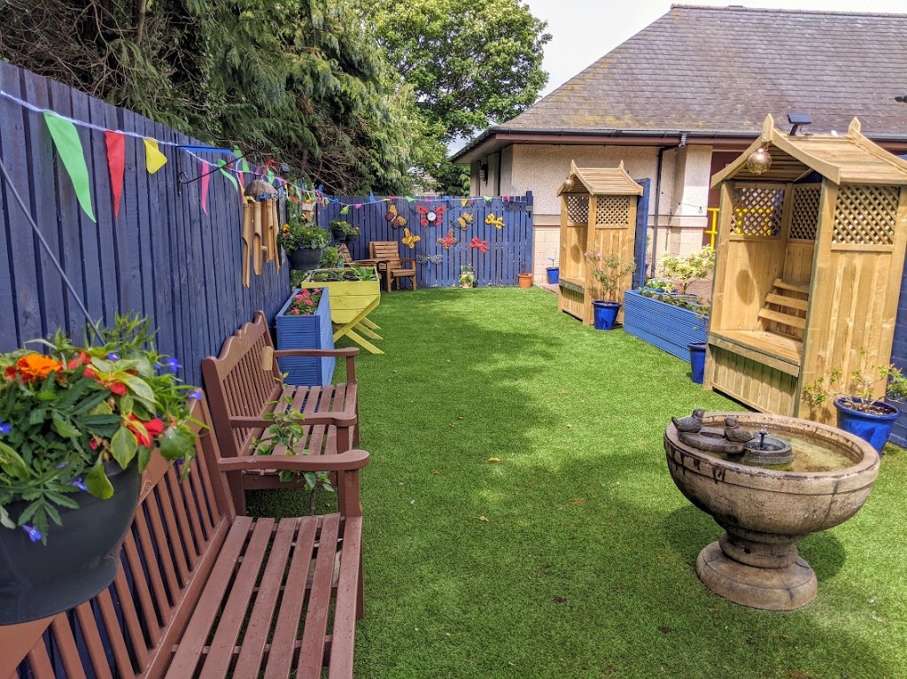 A view of the hospital garden, showing seats and planters.
